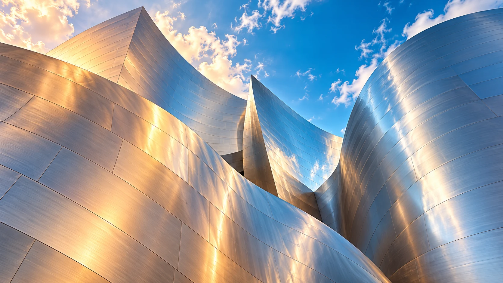 Sweeping brushed-steel architectural curves reflect warm sunlight and cool blue sky.